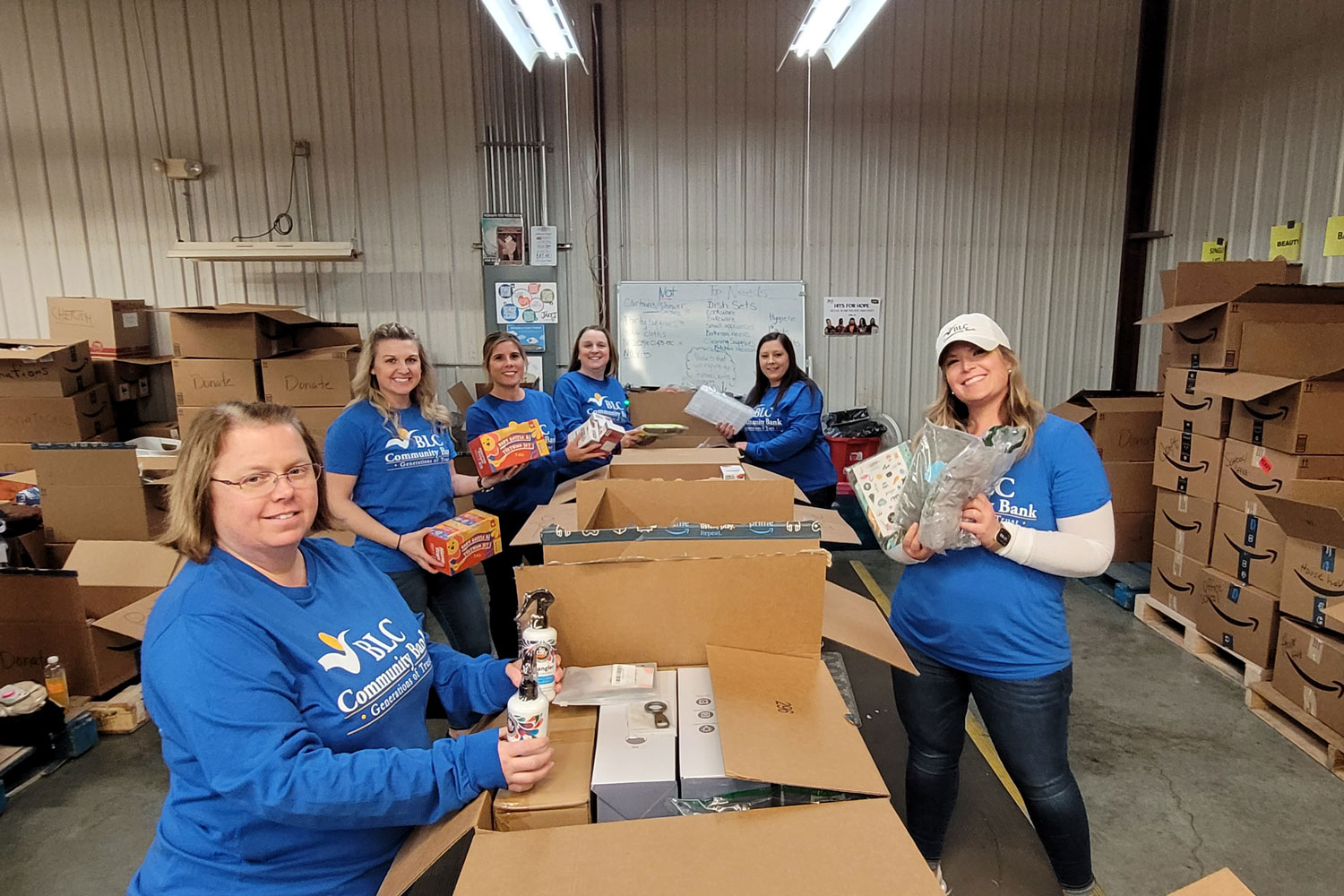 Members of BLC Community Bank help unpack boxes for Jake's Network of Hope Hope Hub